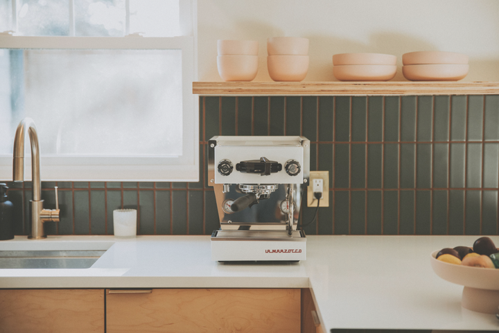 La Marzocco Linea Micra in white – lifestyle shot in a bright kitchen – Coffee Coaching Club